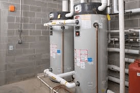 Utility room with a big water heater and pipes.