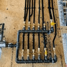 A collection of pipes and hoses neatly arranged on a wooden table.
