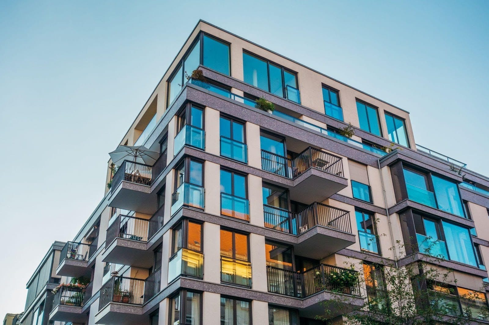 Sleek modern apartment building with numerous balconies and expansive windows highlighting urban living aesthetics