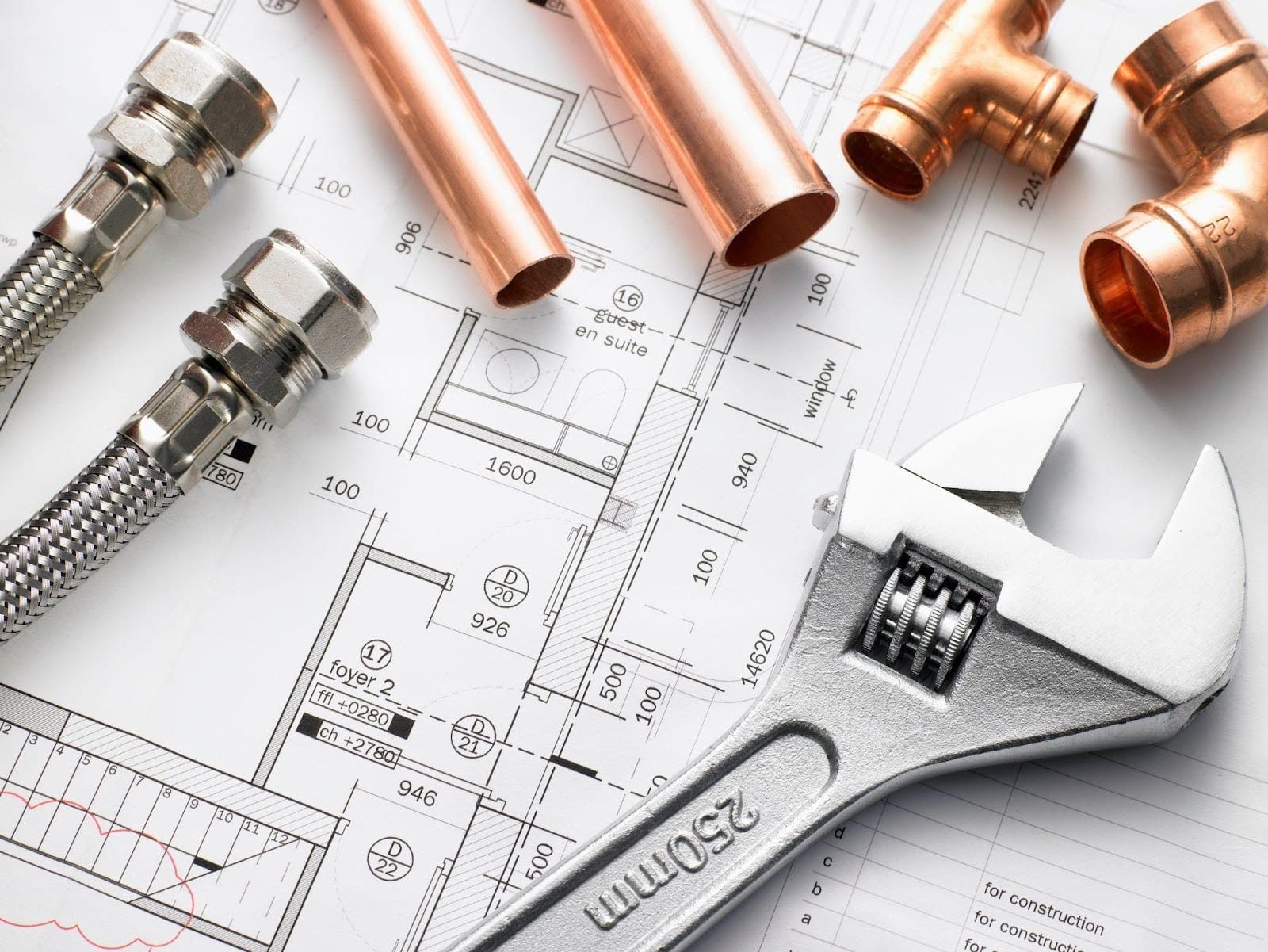 Plumbing supplies and fixtures illustrated on a detailed blueprint layout for a construction project