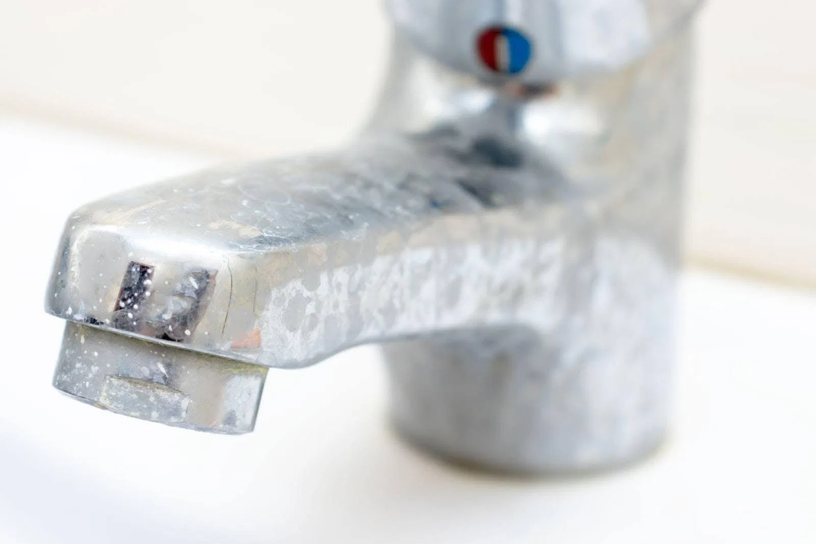 Close-up of a metal faucet handle showcasing its sleek design and polished surface