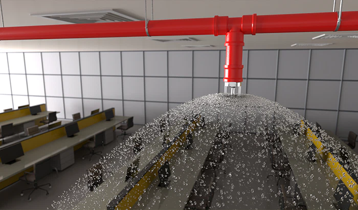 A red pipe from the Sprinkler Systems sprays water into a room, preventing fire damage.