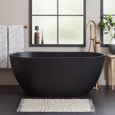 Black bathtub in bathroom with windows in custom residential home