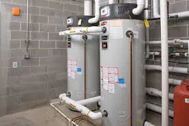 Utility room with a big water heater and pipes.