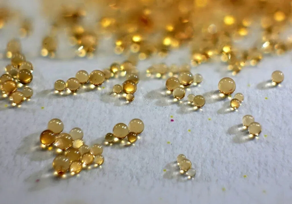 Gold glitter scattered on a white surface creating a sparkling and festive appearance